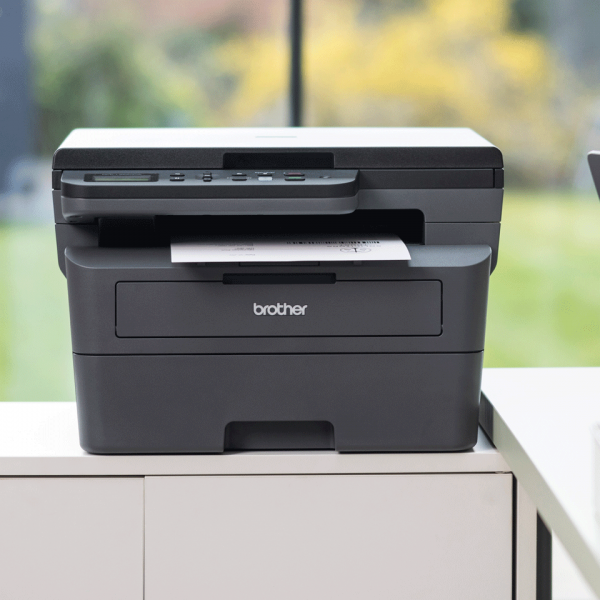 Brother laser printer on office desk, printing document, ideal for business IT hardware