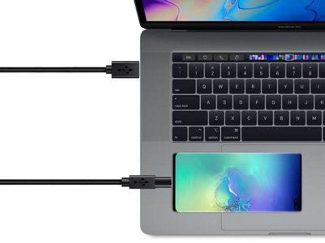 USB-C cable connecting laptop to smartphone, ideal for data transfer and charging